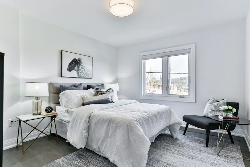Witte slaapkamer met opgemaakt bed
